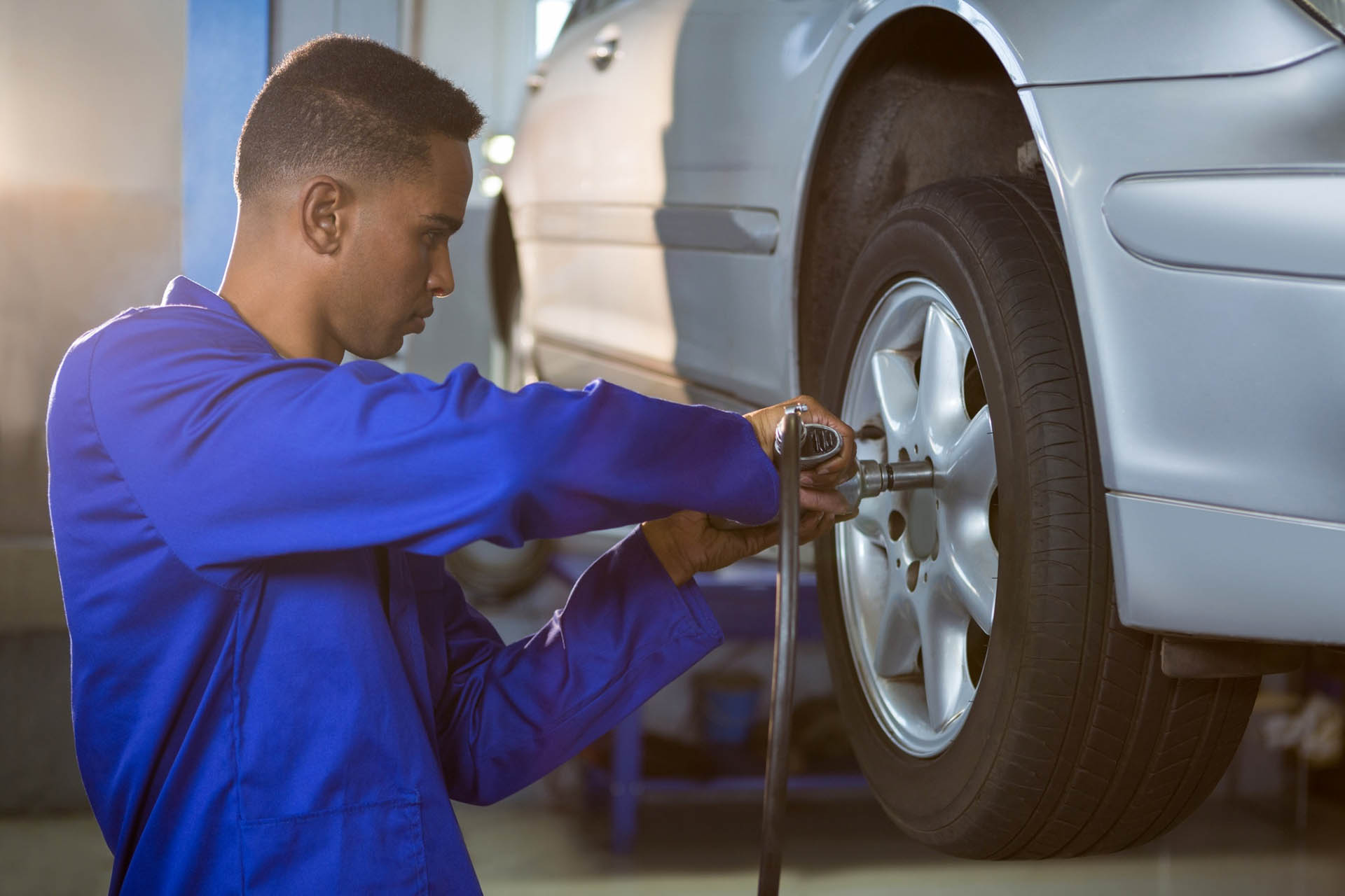 mechanic-fixing-car-tyre copy